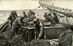 “Baiting Up” – Fishing lines are readied to be cast into the sea